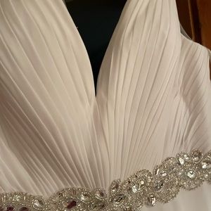 Brand new wedding dress never worn or altered.  Size 14, stored in zippered bag.